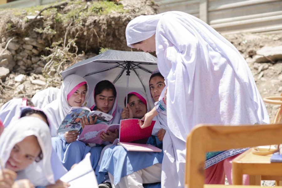 The girls are taking classes outside because there is no school facility. The umbrella is not just there to protect them from the rain, but also from the sunlight and the eyes of men. (Kyo Shimizu, Pakistan)
